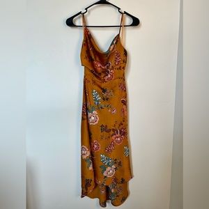 Dark yellowish/orange floral print dress. High/low cut.